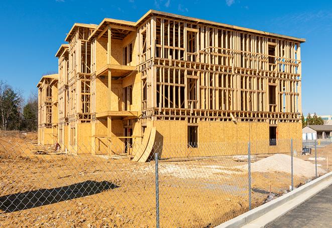 a close-up of temporary chain link fences enclosing a job site, signaling progress in the project's development in Syracuse, NY